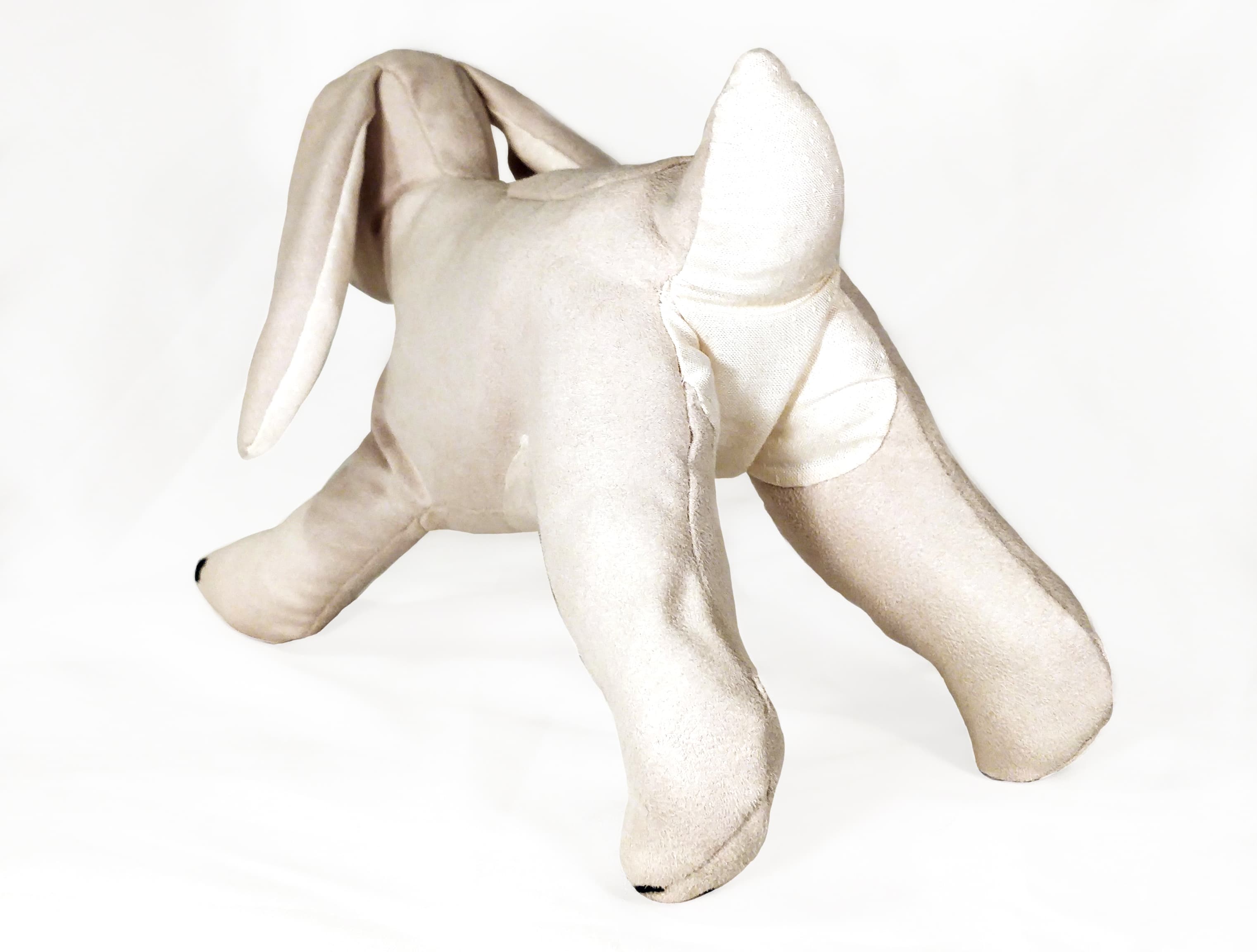 a soft toy rabbit, showing the plumetis tail and tummy