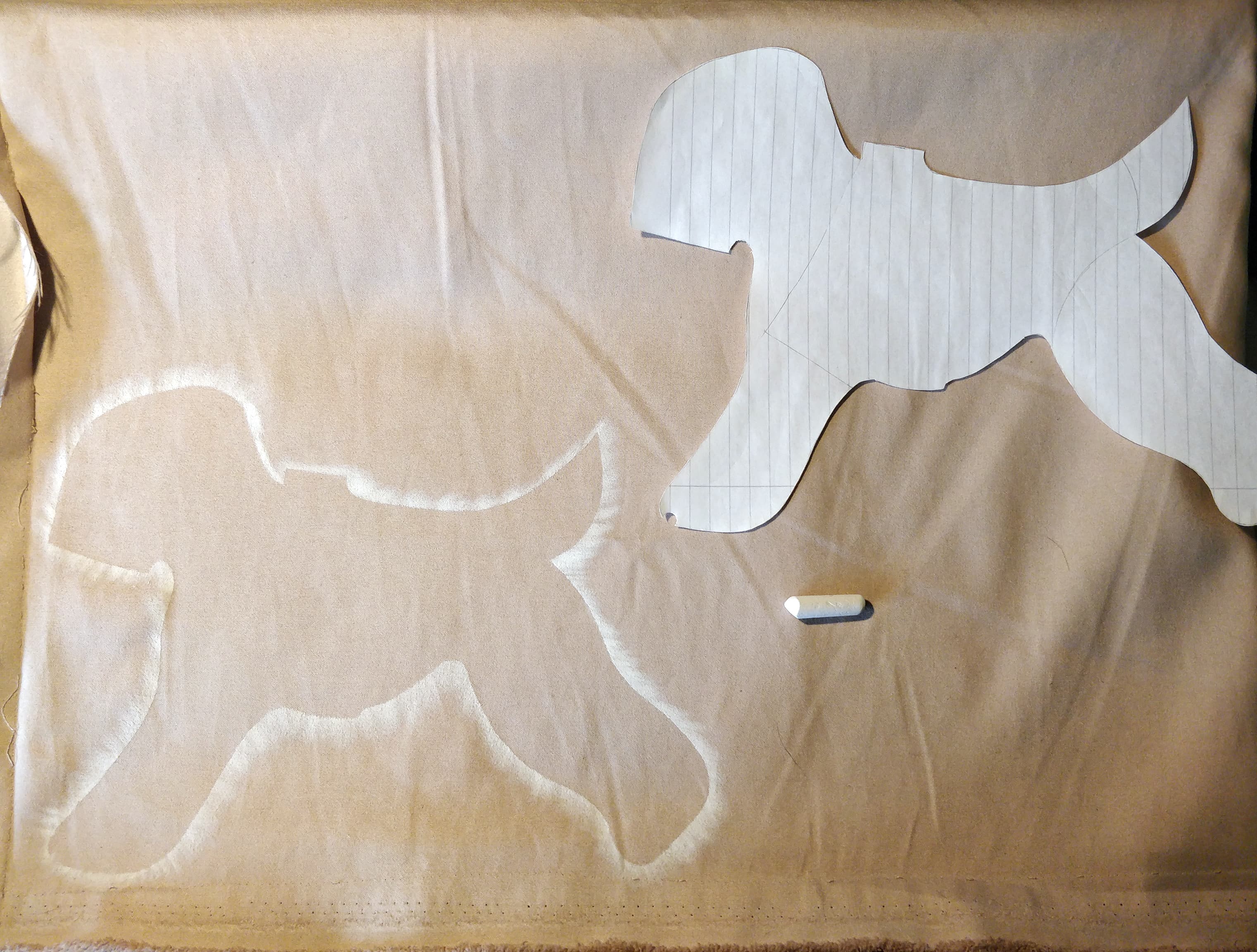 chalk silhouette of a template transferred onto the faux suede