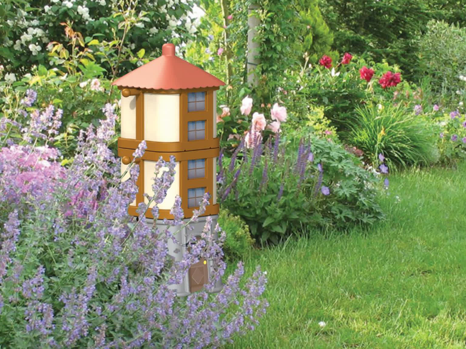 Thumbnail image: A garden composter, shaped like a moomin house, pictured in a flowery garden