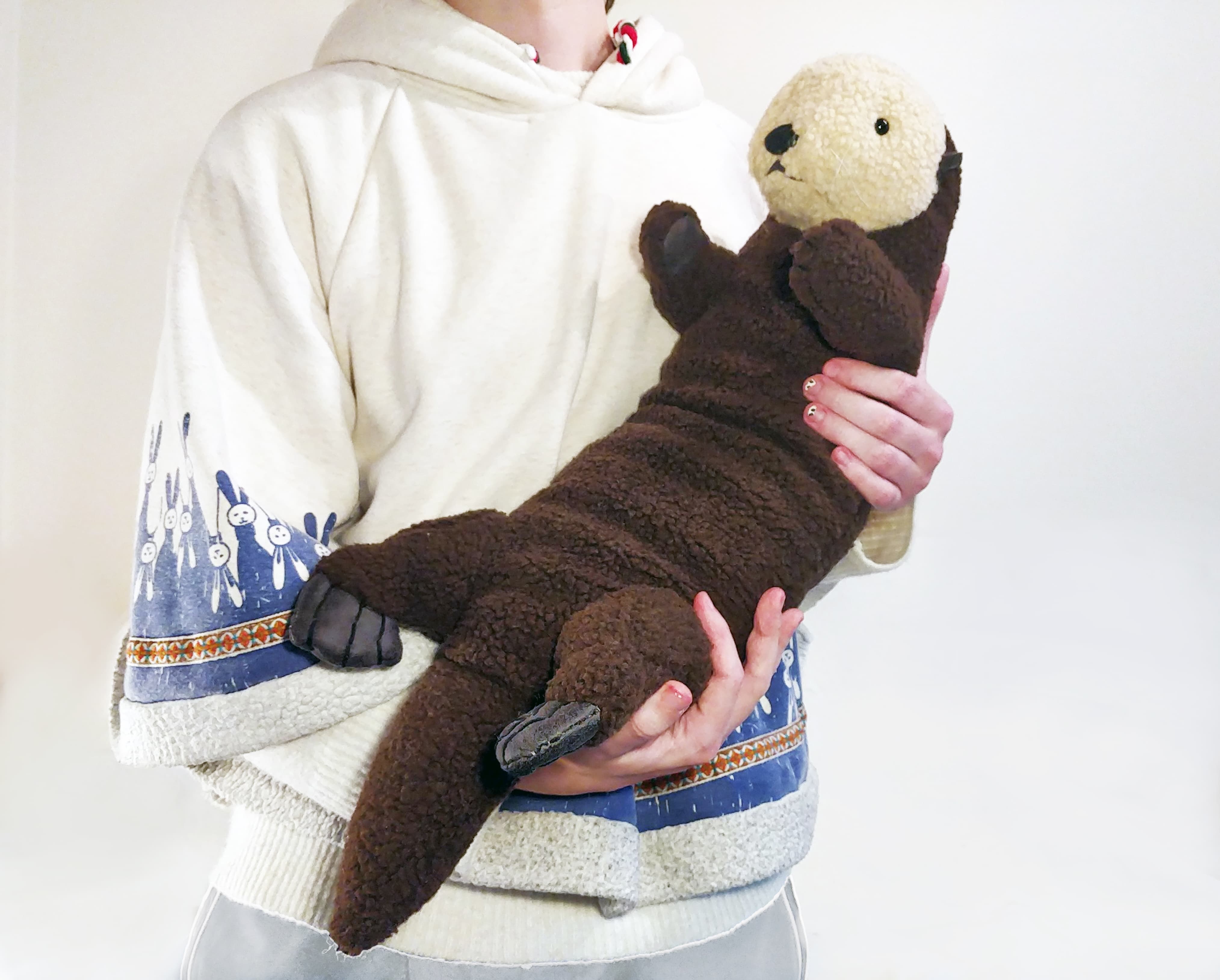 Thumbnail image: A figure holding a stuffed toy otter
