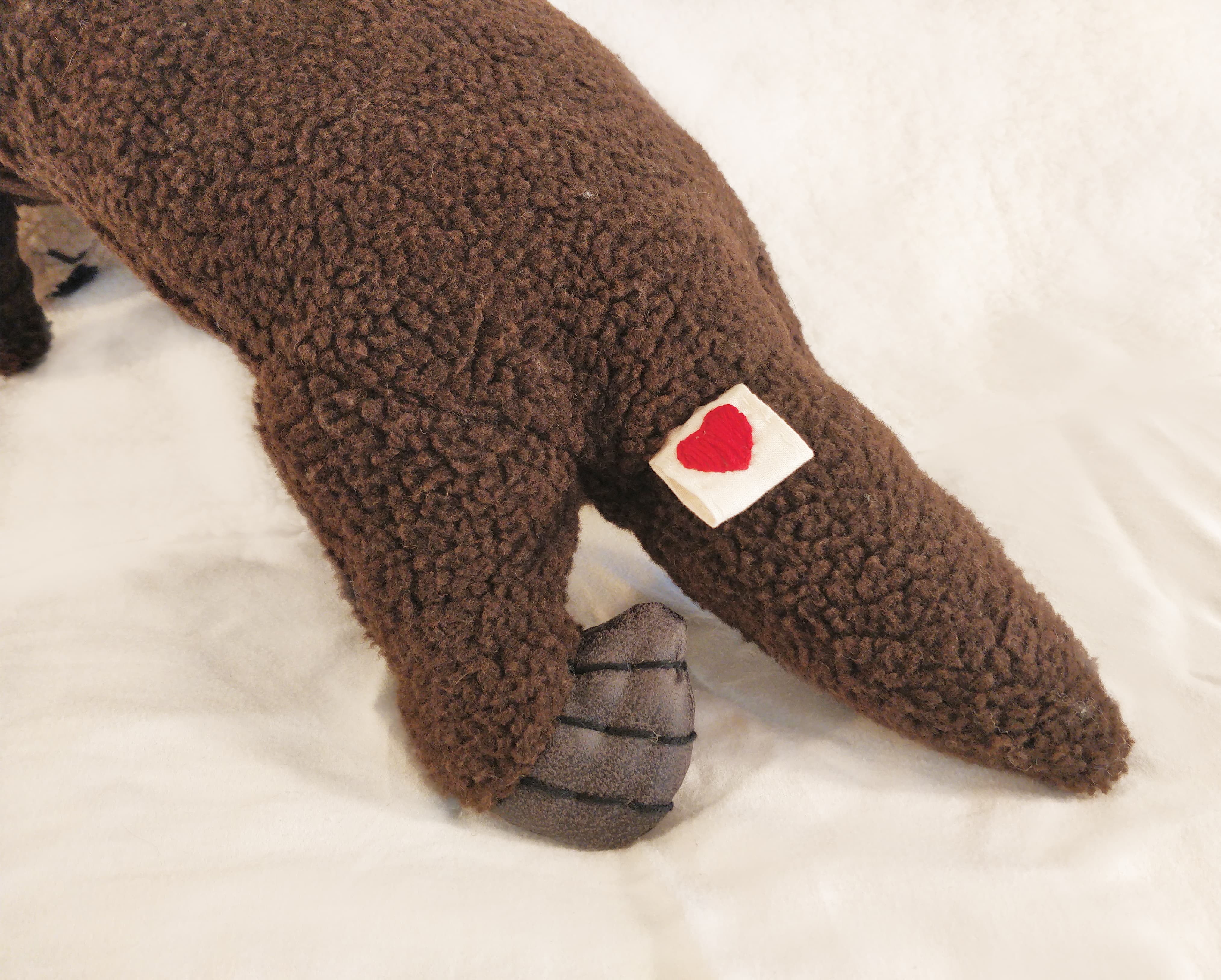 Soft toy otter feet and tag detail