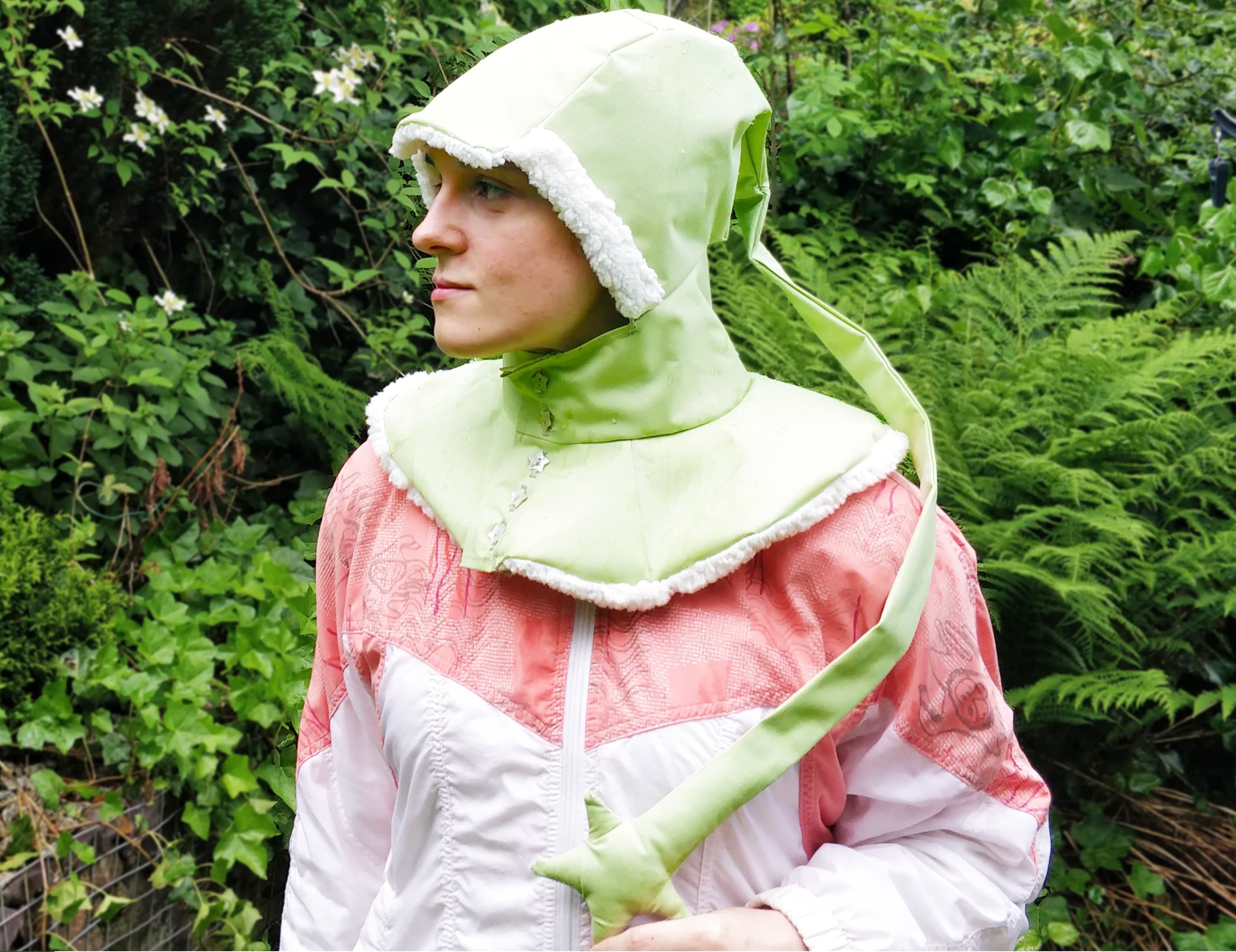 A green liripipe rain hood, made from cordura, showing the star-ended tail